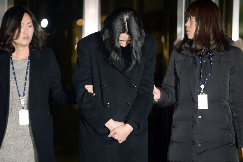 Former Korean Air Vice President Cho Hyun-ah (centre) emerges from the Seoul Western Prosecutors' Office after being arrested for violating aviation security and other laws.