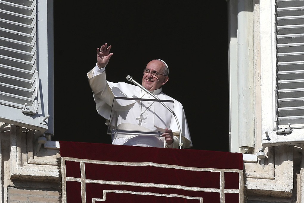 Pope Francis waves during his Angelus prayer in Saint Peter's Square at the Vatican on Sunday. Photo: Reuters