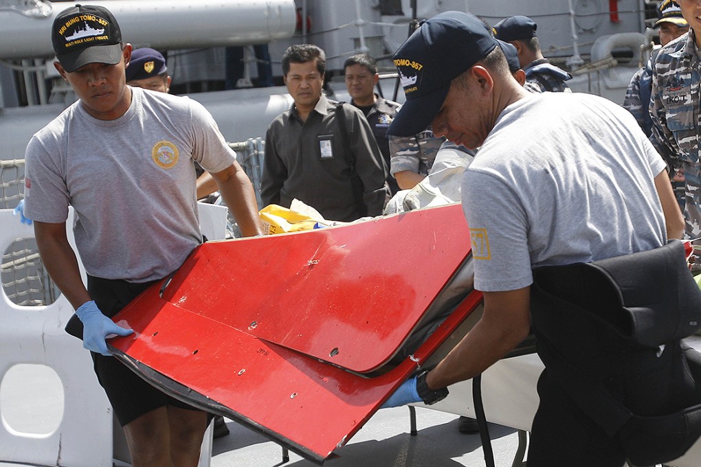 A piece believed to be part of the tailplane from AirAsia Flight 8501 is shown at the Indonesian Navy's Eastern Fleet Naval Base in Surabaya. Photo: AP