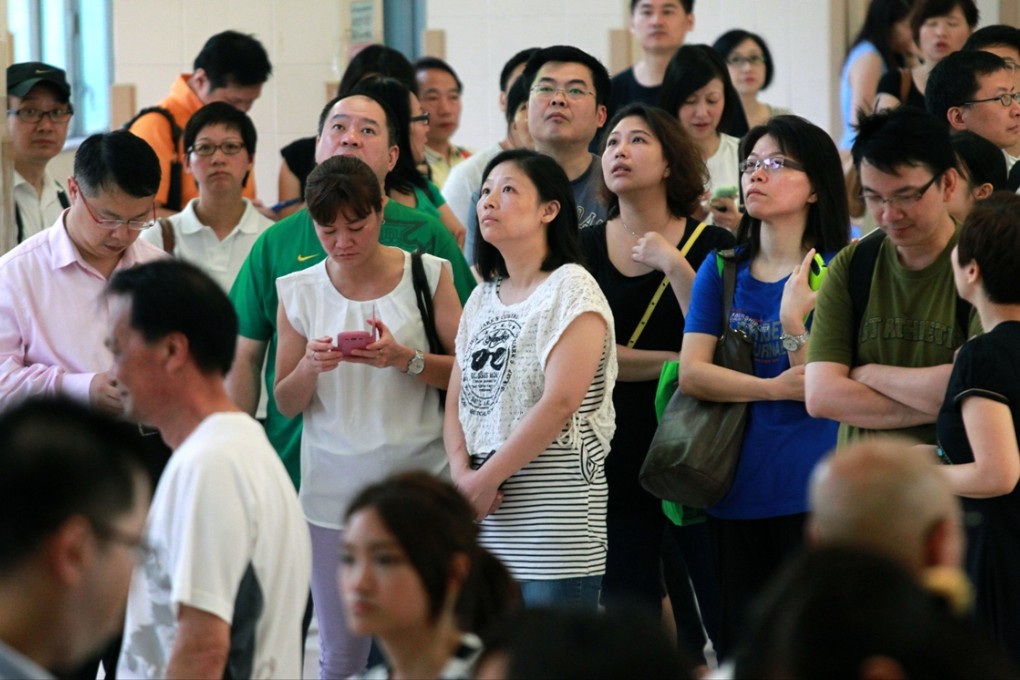 Parents wait for their children at a primary school. Photo: Dickson Lee
