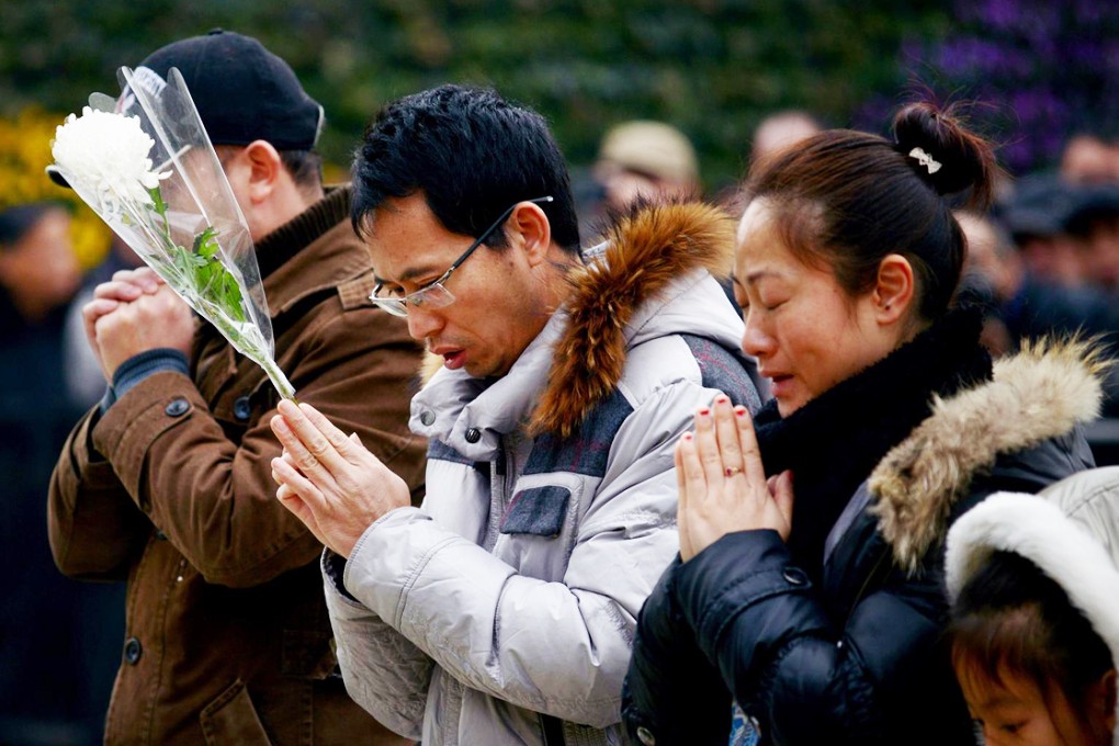 People pray for victims at the site of the stampede. Photo: AFP