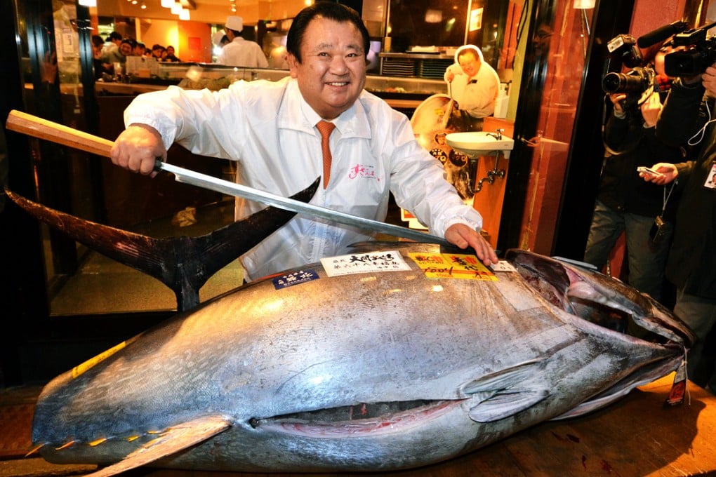 Kiyoshi Kimura displays the 180kg bluefin tuna his company bought for 4.51 million yen. His sushi chain has won the new year auction at Tsukiji fish market for four years running. Photo: AFP