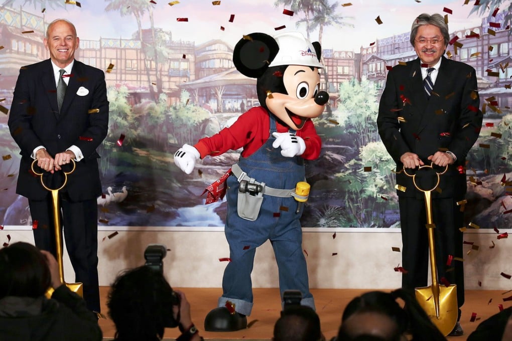 Bill Ernest, Asia president of Walt Disney Parks and Resorts, and Financial Secretary John Tsang join Mickey Mouse at the groundbreaking ceremony. Photo: Jonathan Wong