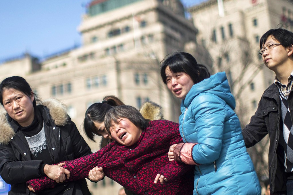 A woman cries as she mourns her relative, a victim who was killed in a stampede during the new year celebrations on the bund, in Shanghai. Photo: Reuters