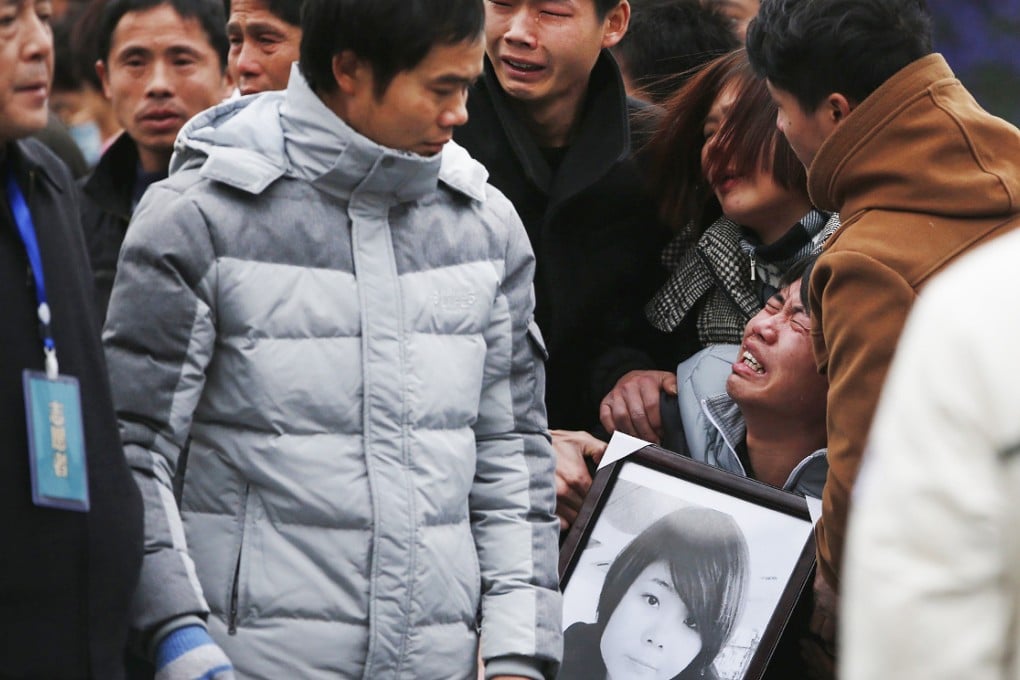 A distraught relative collapses in grief at the scene of the crush. Photo: Reuters