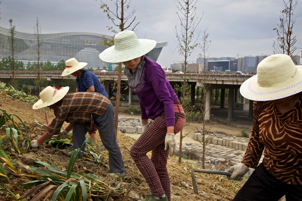 Workers landscaping an area that used to be farmland in Chengdu in western China. Photo: The New York Times