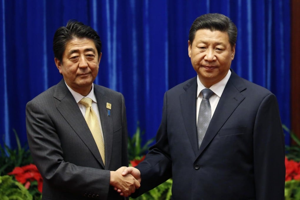Abe and Xi's infamous icy handshake. Photo: Reuters
