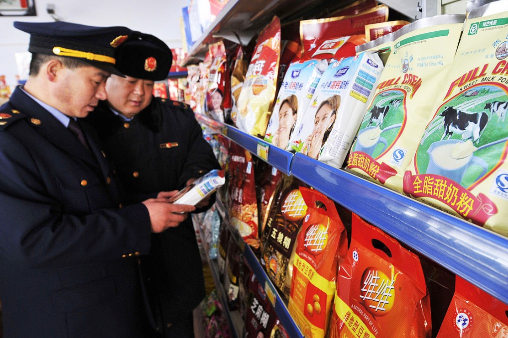 Food and Drug Administration officers check dairy products in a supermarket in Rizhao in the eastern province of Shandong in this file picture. Photo: AP