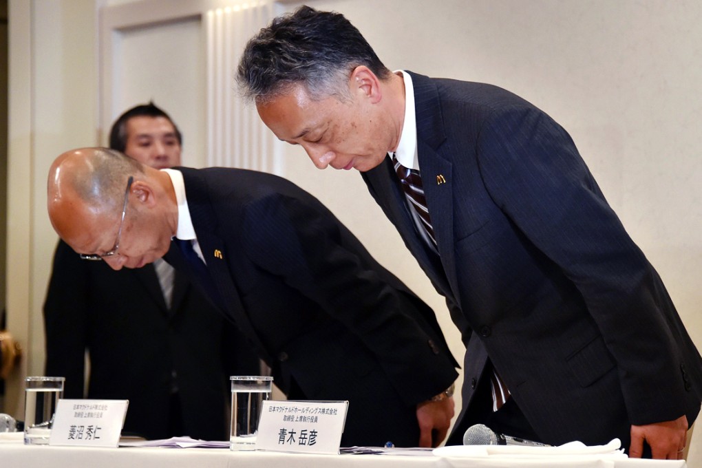 McDonald's Japan executives Takehiko Aoki (right) and Hidehito Hishinuma bow in apologies at a press conference. Photo: AFP
