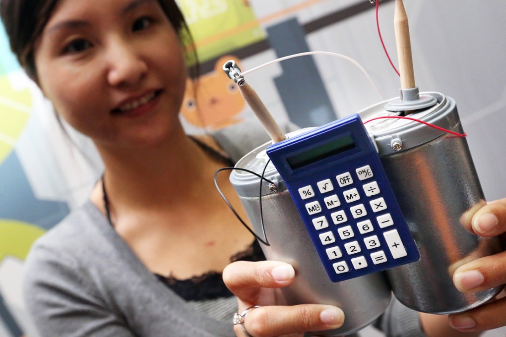 A representative of 4m Industrial Development shows off its "tin can calculator". Photo: K. Y. Cheng