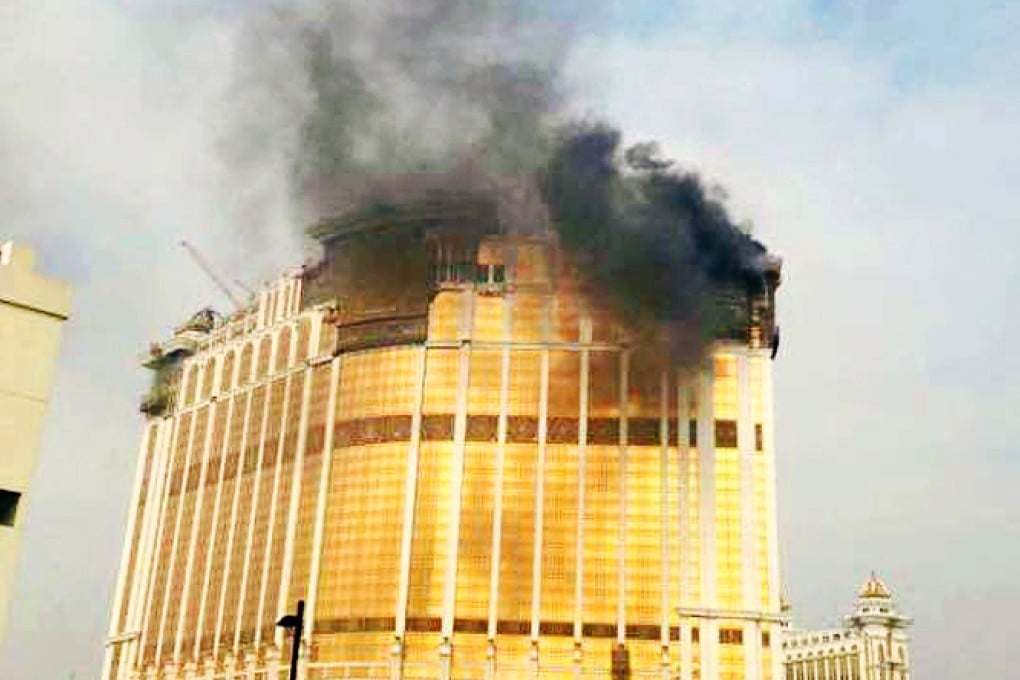 Smoke poured from the roof of the unfinished 36-storey Galaxy Macau building. Photo: SCMP Pictures