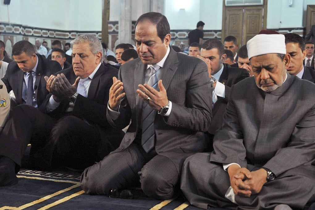 Egypt's President Abdel-Fattah el-Sisi (centre), the Grand Sheik of Al-Azhar, Ahmed el-Tayeb, (right) and Prime Minister Ibrahim Mehleb, (left) pray on the first day of Eid ul-Fitr in this file picture from October. Photo: AP