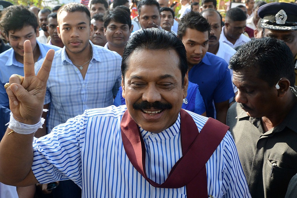 A confident President Mahinda Rajapaksa flashes a victory sign outside a polling station in his native town of Tangalla on Thursday. Photo: AFP