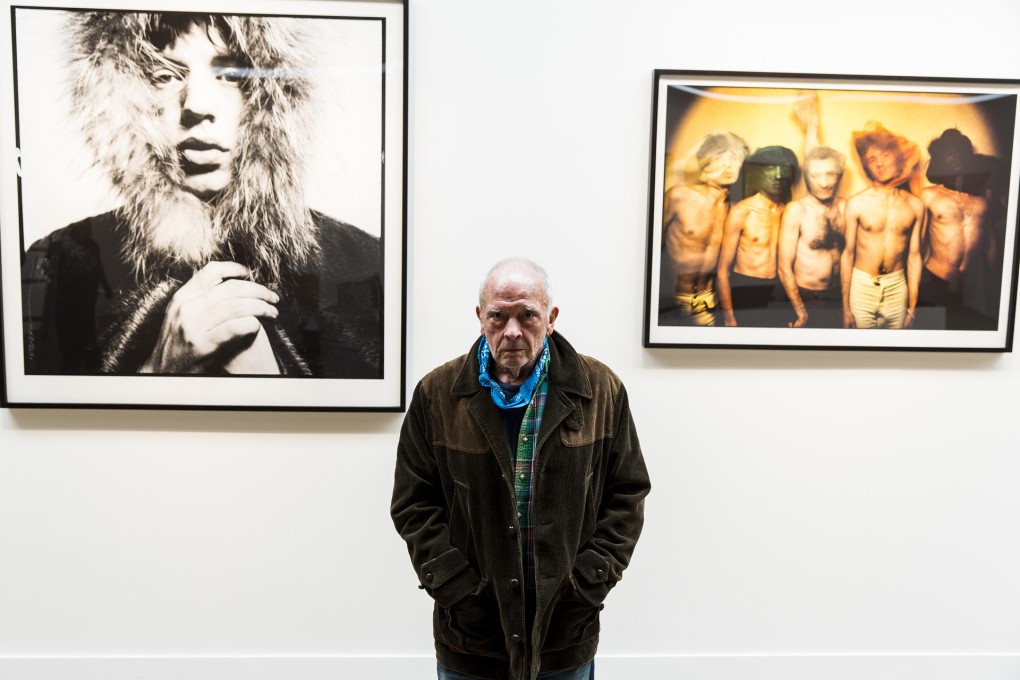 David Bailey with two of his photographs of the Stones at the Taschen Gallery show, which ties in with the launch of a book about the band. More images at the exhibition (below). Photo LA Times