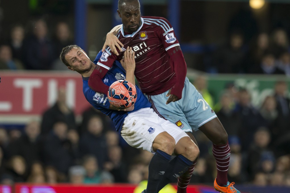 Everton's Philip Jagielka (left) fights for the ball against West Ham United's Carlton Cole. The Toffees are struggling to keep their heads above a downward spiral to the relegation zone. Photo: AP