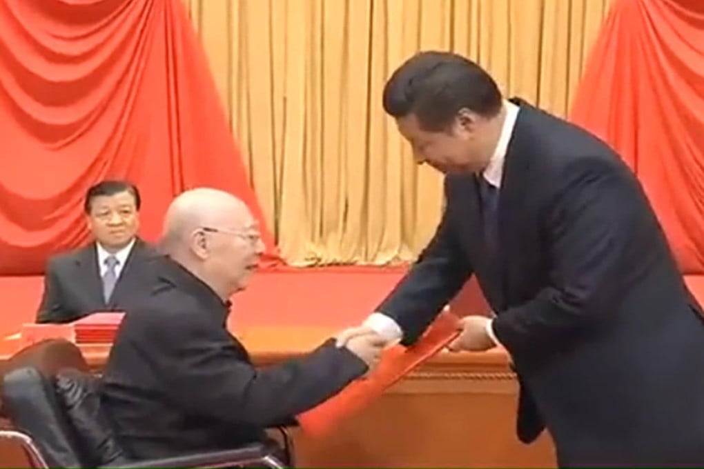 Yu Min (seated) is honoured by President Xi. Photo: SCMP Pictures