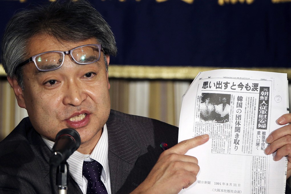 Takashi Uemura, a former journalist with the Asahi newspaper, shows a copy of his story on comfort women during a press conference in Tokyo on Friday. Photo: AP
