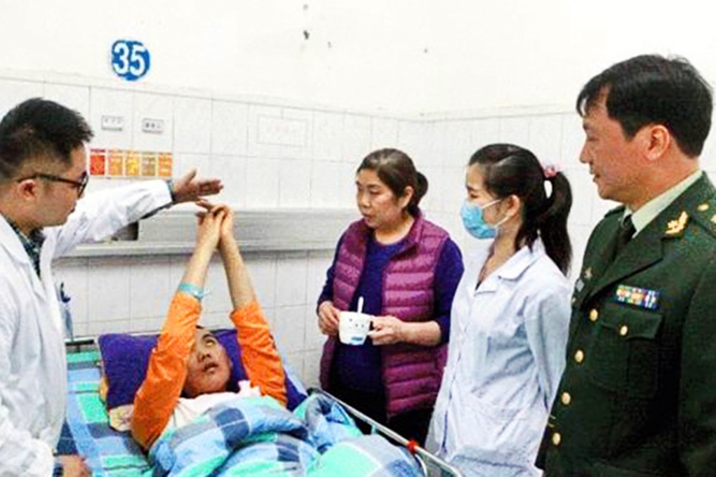 A Shenzhen man who suffered a stroke in 2013 suddenly moved when a nurse asked him to grab a 100-yuan note. Photo: SCMP Pictures