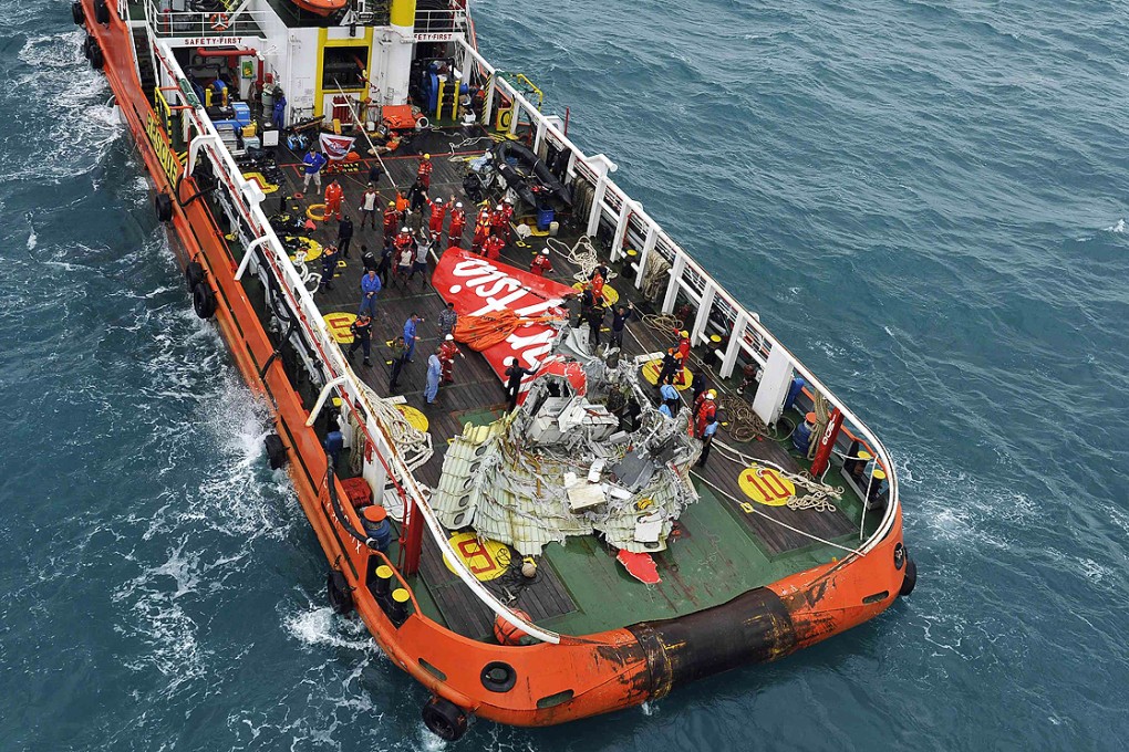 The tail of AirAsia QZ8501 on the deck of an Indonesian rescue ship after it was lifted from the sea bed on Saturday. Photo: Reuters