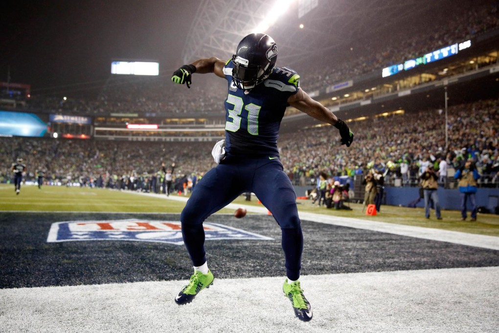 Seattle Seahawks defender Kam Chancellor celebrates after scoring a 90-yard touchdown off an interception at CenturyLink Field. Photo: AFP
