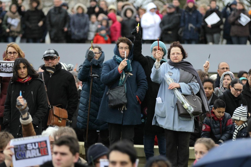 Pencils are held up in Caen in support of the magazine.