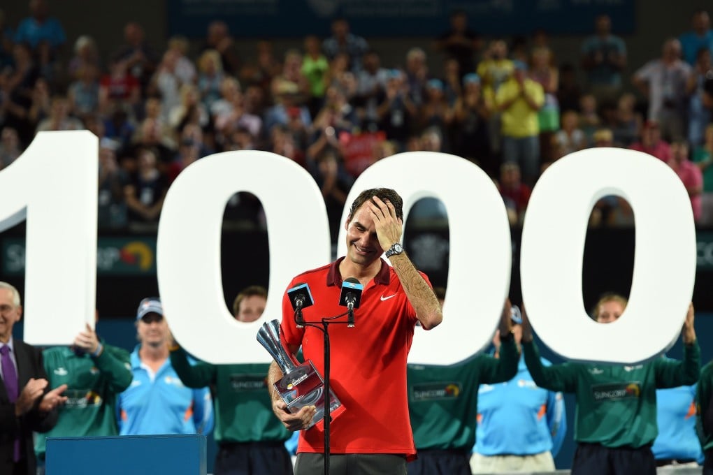 Roger Federer is overcome by emotion at the awards presentation after his milestone win in  Brisbane. Photos: AFP
