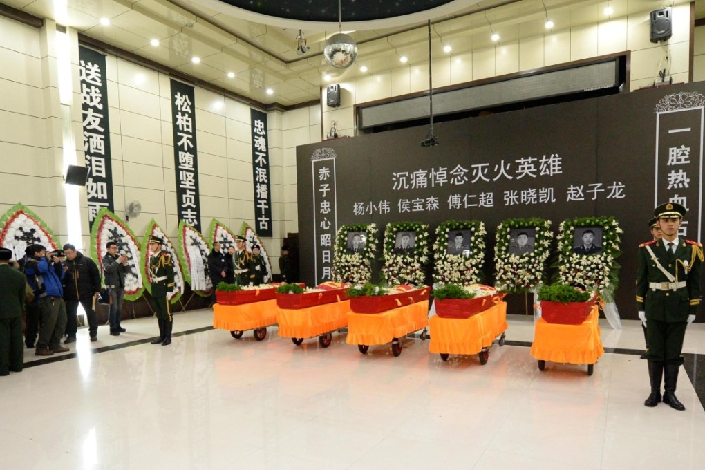 Caskets at the funeral for five firefighters in Harbin. Photo: Xinhua