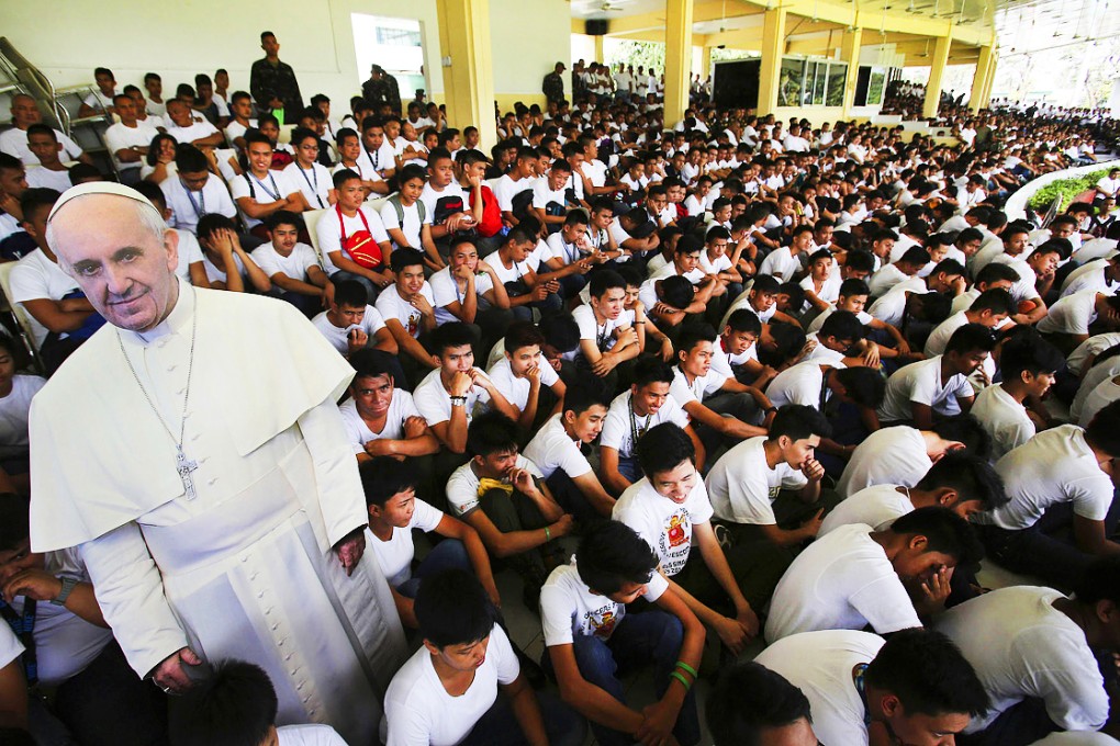 A cut-out picture of Pope Francis is surrounded by Filipinos as part of preparations for his visit. Photo: AP