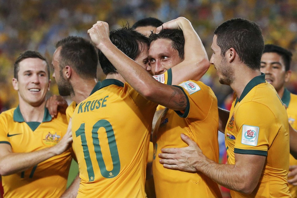 Australia's Mark Milligan (second right) celebrates with teammates after slotting a penalty against Oman in their 4-0 win. Photo: Reuters