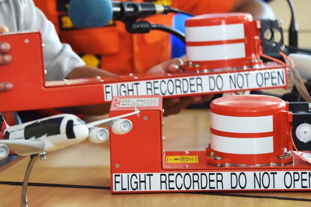 Samples of the flight data recorder (FDR) (top) and the cockpit voice recorder (CVR) (bottom) during a press conference by Indonesian officials about the status of recovery operations on Air-Asia flight QZ8501 in Pangkalan Bun. Photo: AFP