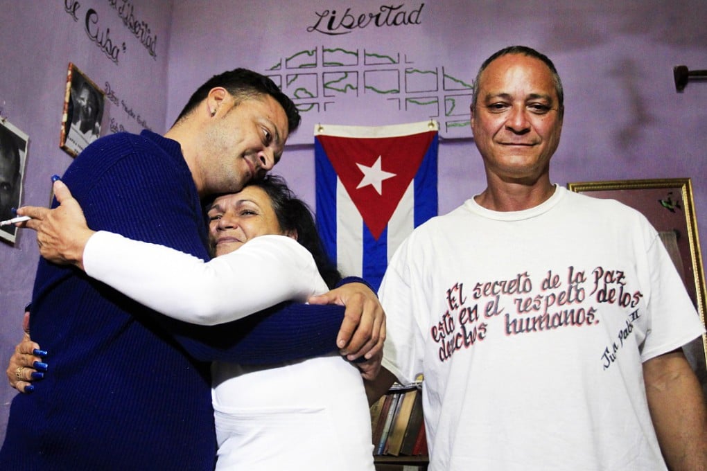 Angel Figueredo (right) and wife Haydee Gallardo, a member of the Ladies in White dissident group, were among the detainees freed in Cuba. Gallardo hugs their son Reynier at their home. Photo: Reuters