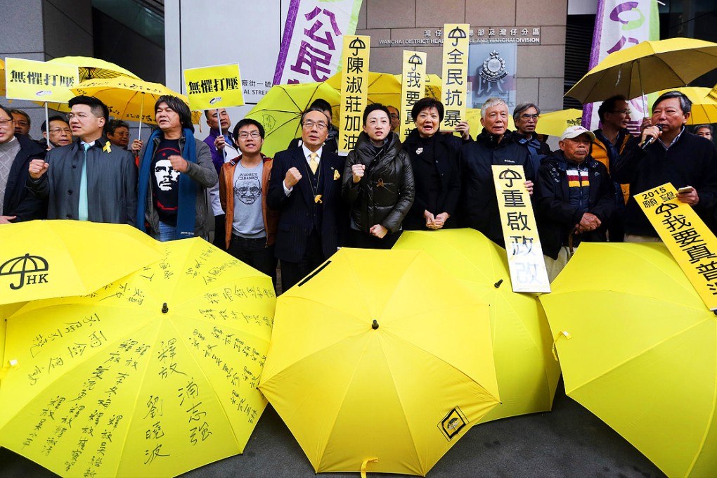 Tanya Chan (centre) reports to police at in Wan Chai. Police have asked activists for help with their investigation, but the activists don't plan to cooperate. Photo: Sam Tsang
