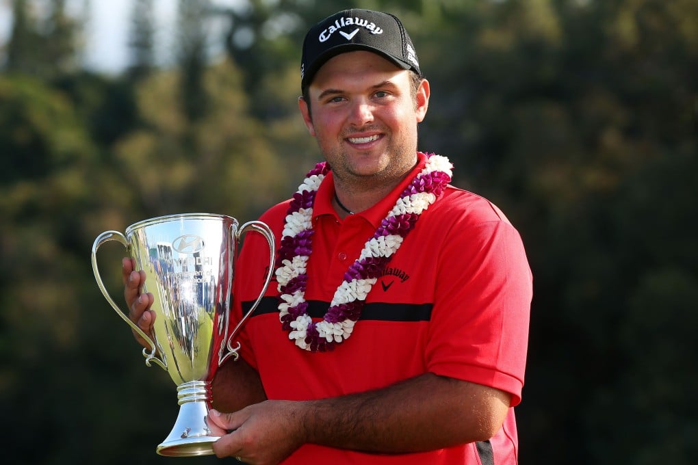 Patrick Reed with the trophy. Photo: AFP