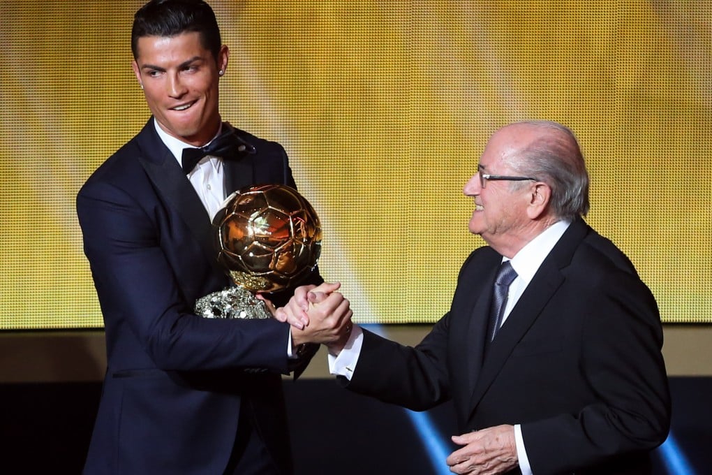 Cristiano Ronaldo receives the trophy from Fifa president Sepp Blatter. Photo: Xinhua