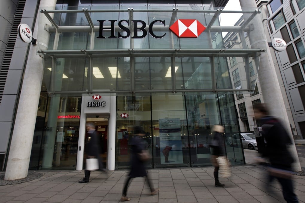 Pedestrians walk past an HSBC branch in London as the bank's Argentina branch was suspended from transferring money for 30 days from the country to abroad due to irregularities. Photo: Bloomberg
