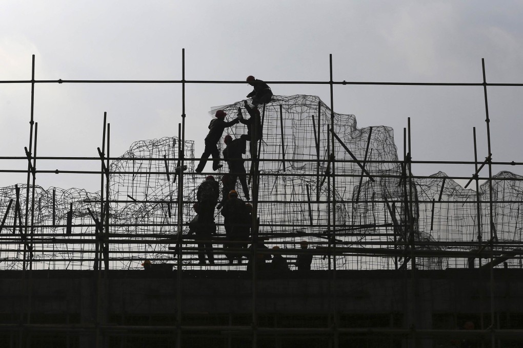 Construction workers in Kunming, Yunnan, climb the scaffolding. China's property market is unquestionably cooling down. Photo: Reuters