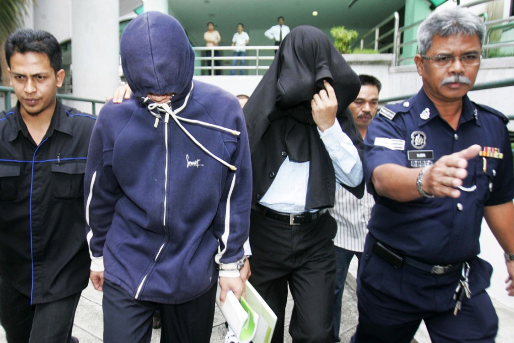 Policemen Azilah Hadri and Sirul Azhar Umar arrive at the courthouse in Shah Alam outside Kuala Lumpur in this 2009 photo. Photo: Reuters