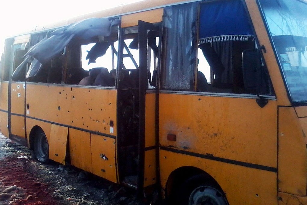 Blood stains the ground around the damaged bus after seven women and four men lost their lives in a rocket attack apparently intended for a government checkpoint. Photo: AFP