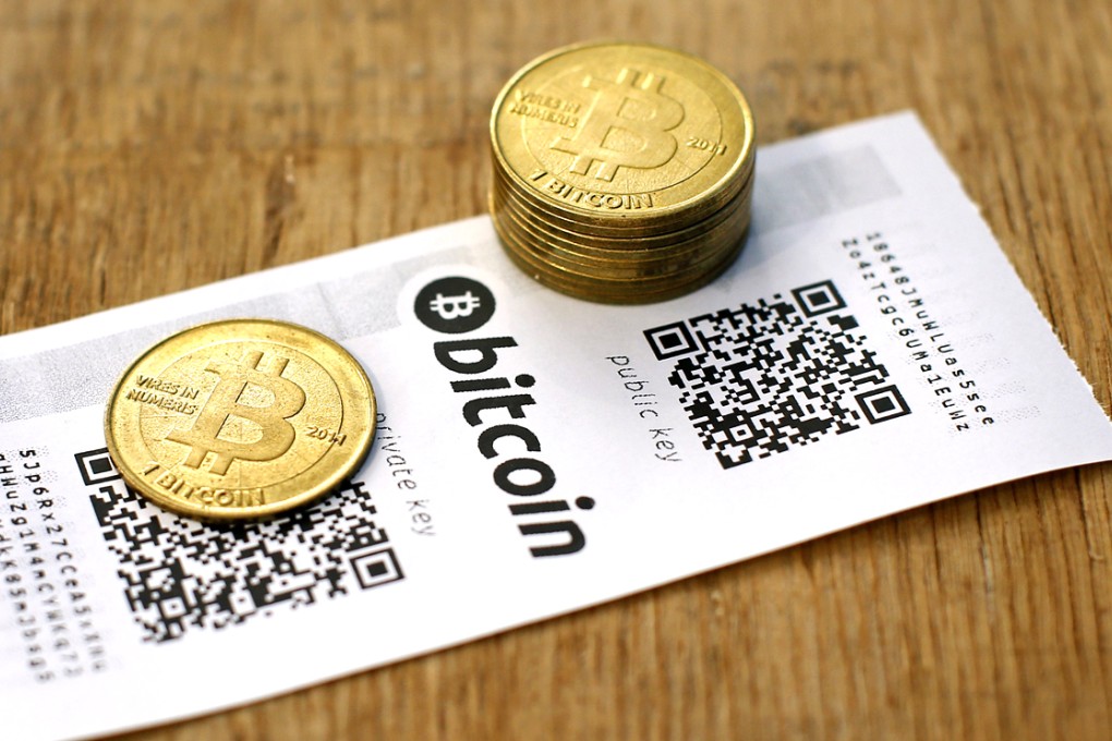 A Bitcoin paper wallet with QR codes and coins are seen in an illustration picture taken at La Maison du Bitcoin in Paris. Photo: Reuters