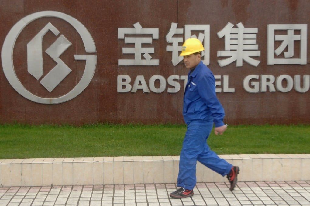 A worker strides past logo of Baoshan Iron & Steel. The most profitable steel company in China said its net profit was flat. Photo: Reuters