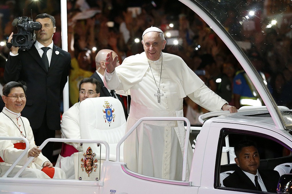 Pope Francis waves to wellwishers in Manila. Photo: AP
