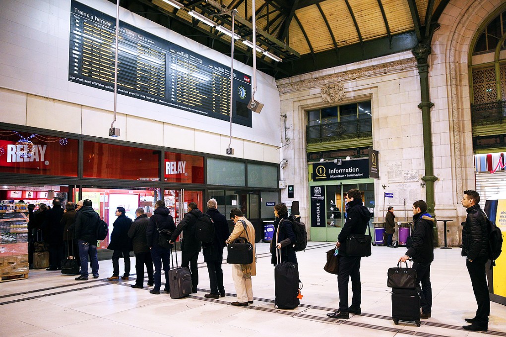 French commuters queue to buy the new edition of the satirical magazine Charlie Hebdo at Gare de Lyon train station in Paris on Wednesday. Photo: EPA