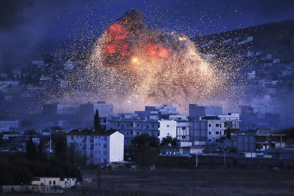 Thick smoke and flames from an explosion following an airstrike by the US-led coalition rise on Kobani. Photo: AP