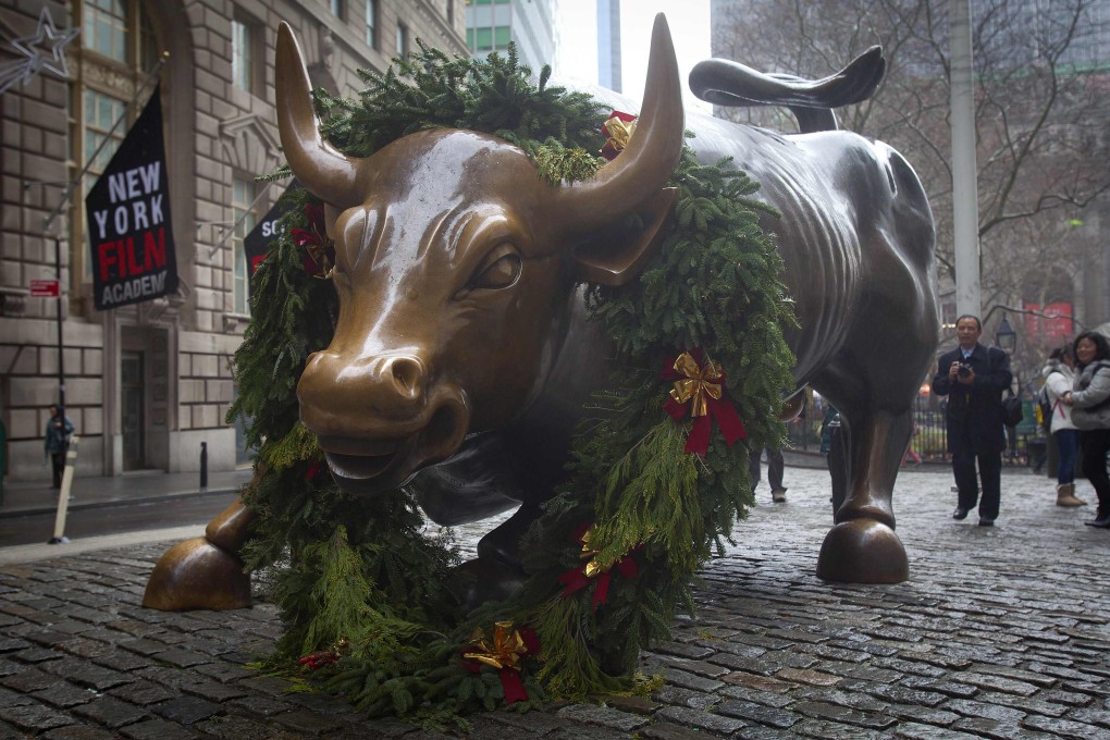 It looks like a year when market bulls -- symbolised by the statue outside Wall Street in New York -- will be running hard in 2015. Photo: Reuters