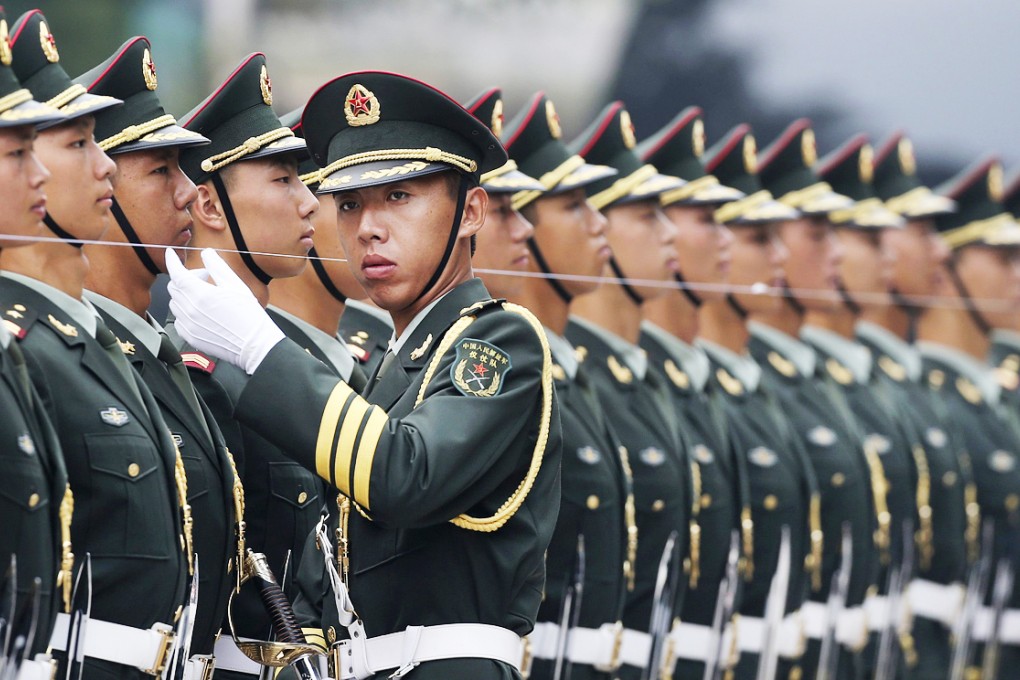 A People's Liberation Army officers checks that members of the honour guard are standing in a straight line before a ceremony in Beijing. Photo: Reuters