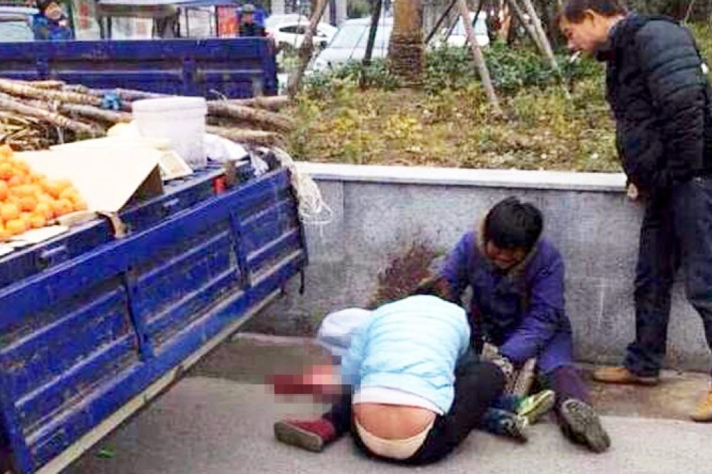The Chinese couple weep over their son's body after he was crushed under the wheels of their truck as they tried to flee from city enforcement officers. Photo: Weibo