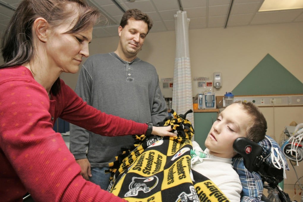 Alex Malarkey with his parents after 2004 car crash. Photo: AP