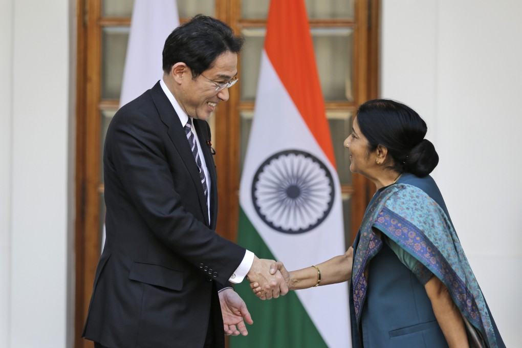 Japanese Foreign Minister Fumio Kishida shakes hand with Indian Foreign Minister Sushma Swaraj before the start of a meeting n New Delhi today. Photo: AP