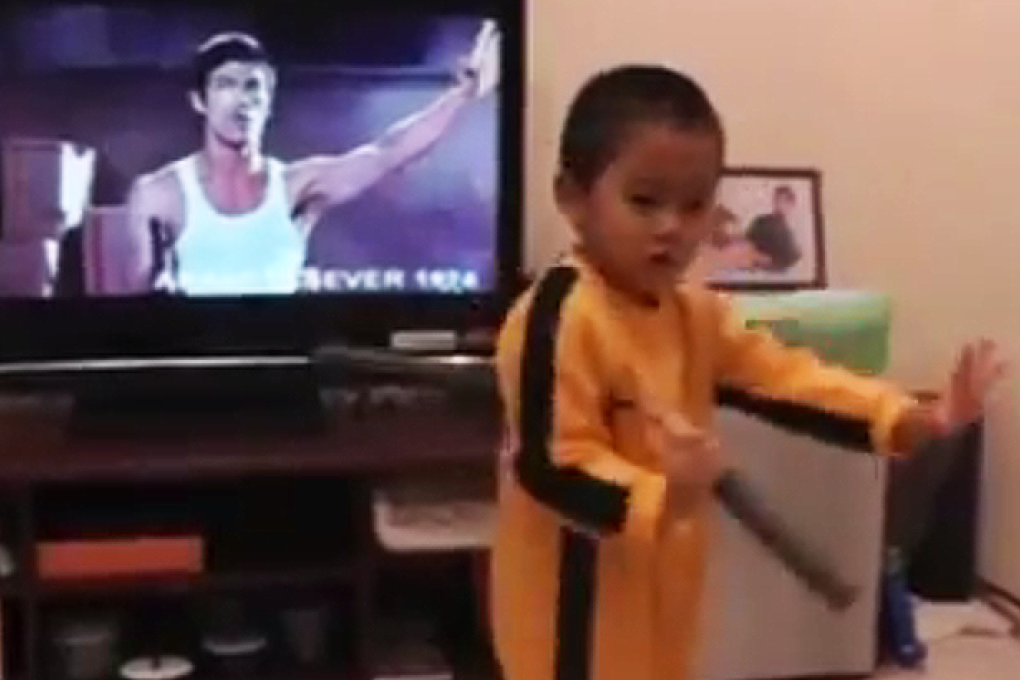 The boy handles the nunchucks with ease, swirling them in unison with the Bruce Lee scenes playing in the background. Photo: YouTube