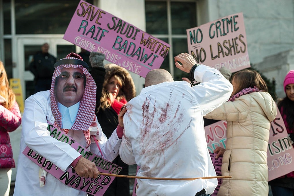 Protesters simulate the flogging in front of the US Saudi embassy in Washington on Thursday. Photo: AFP